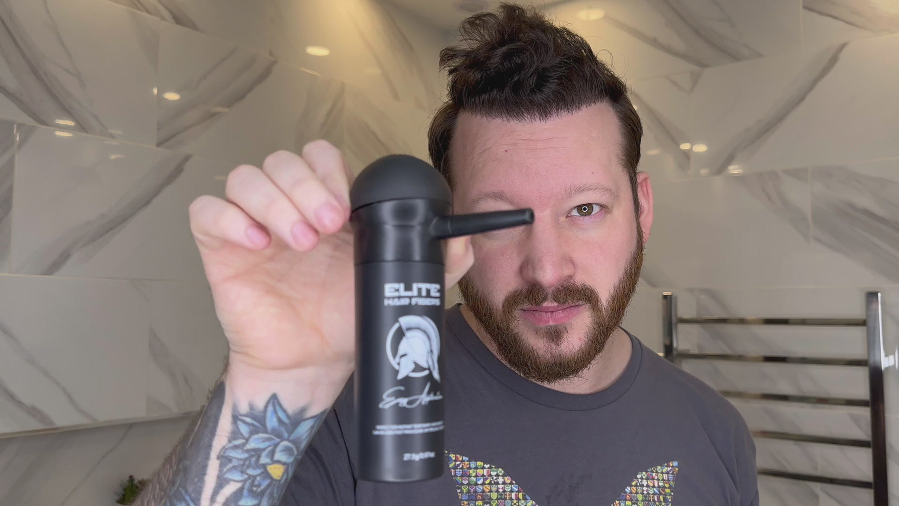 Applying Elite Hair Fibers to hairline with ease using spray applicator